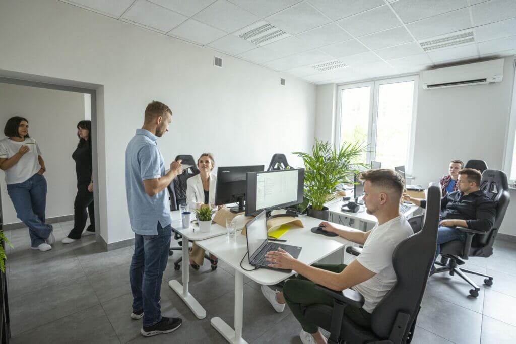 Multishoring Developers working on a custom ecommerce software development project in the office