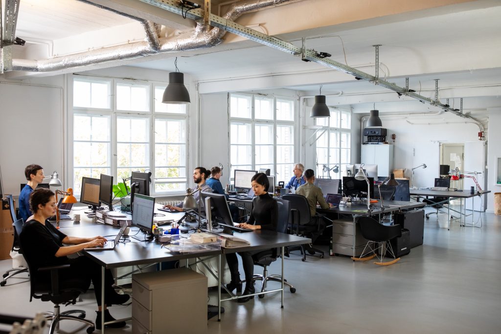 Modern open office space at Multishoring with skilled PIM integration developers collaborating on Product Information Management solutions.
