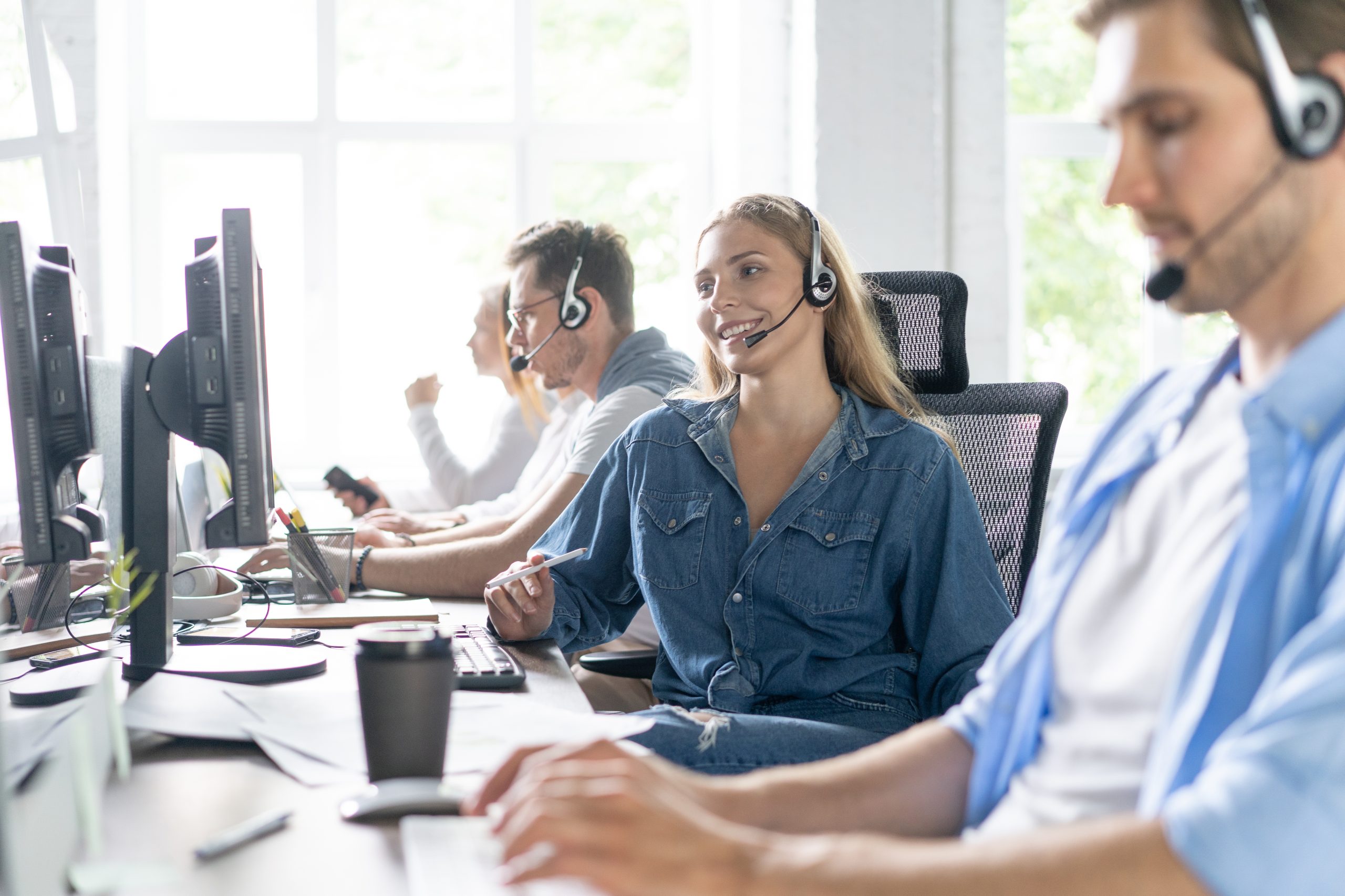 IT professionals providing 24/7 support and software maintenance services at a modern support center.