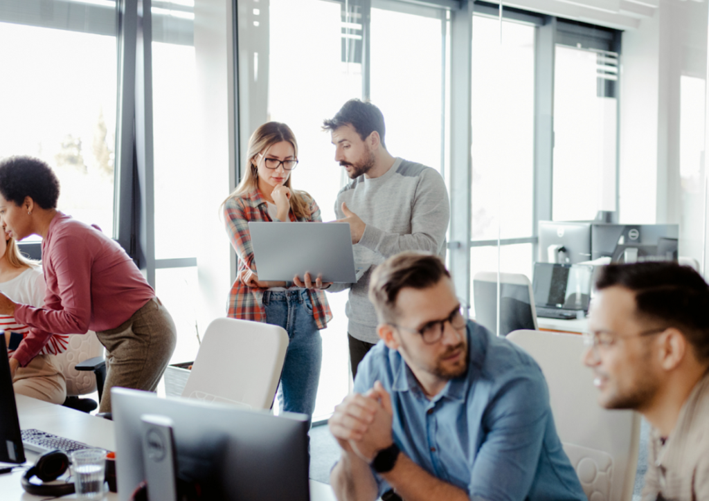 team of developers at work - in-house vs outsourcing software development