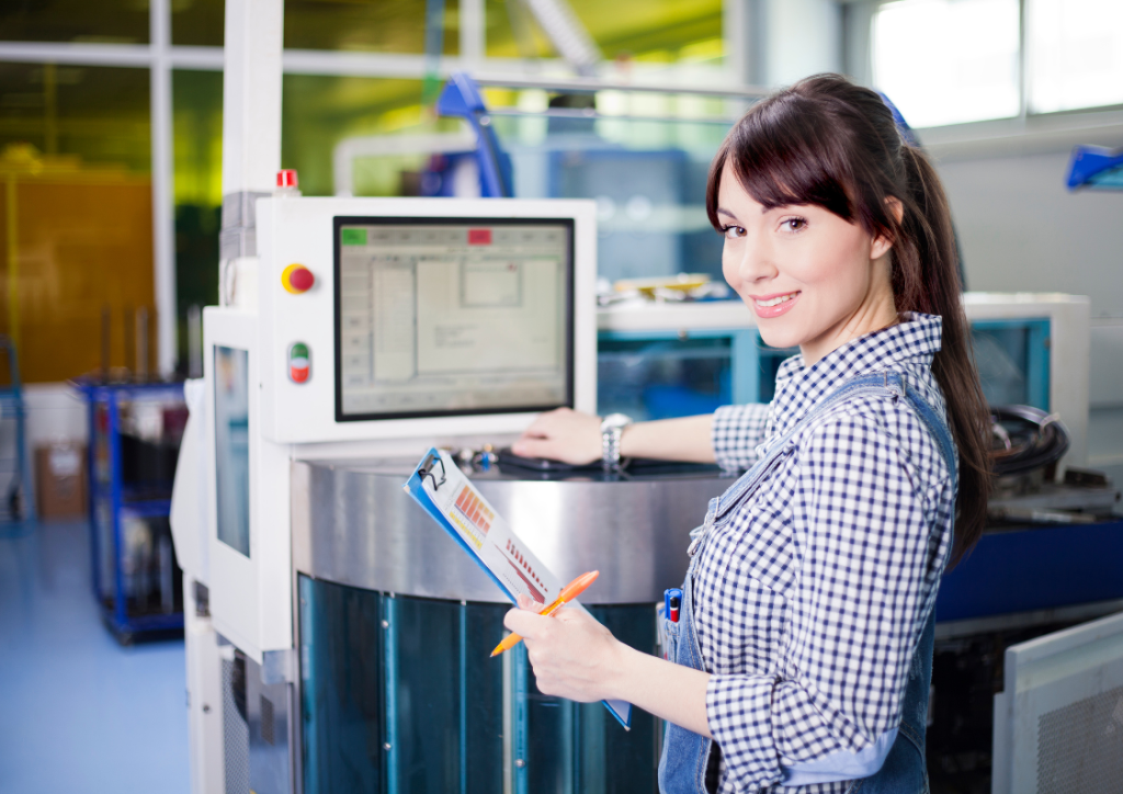 Female manufacturing engineer monitoring production data on a control panel, illustrating Azure-driven operational excellence.